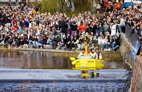 Crowd watching four people riding on a float on 30 April.