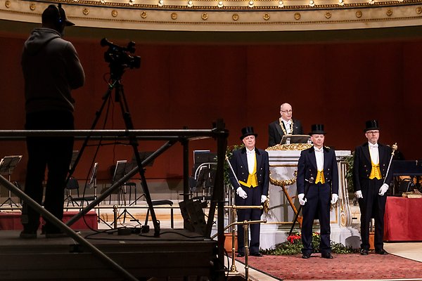 The Vice-Chancellor speaking at the lectern in the Grand Auditorium, with the three ceremonial guards standing before him