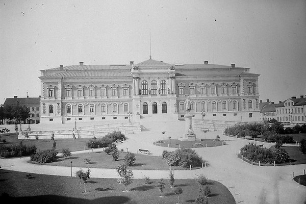 Black and white photograph of the university building with the newly created park outside